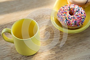 Donut and cup on table