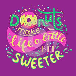 Donuts make life a little bit sweeter. Hand Lettered Phrase on lilac background photo