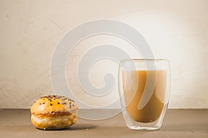 donut in glaze and a cappuccino glass/donut in glaze and a cappuccino glass on a white background