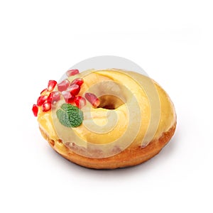 Donut glazed with honey and pomegranate. View from a forty-five degree angle. Isolated image