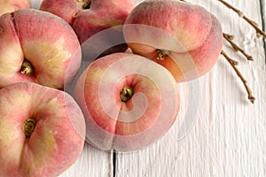 Donut peaches on white rustic table - horizontal image with selective focus photo