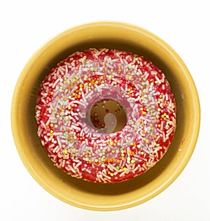 Donut pink with multi-colored pastry crumbs unhealthy dessert