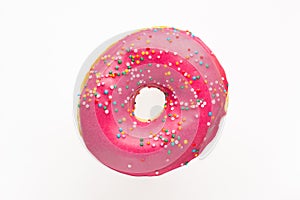 Donut pink with sprinkles isolated on white background, close-up