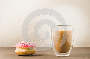 donut in red glaze and a cappuccino /donut in red glaze and cappuccino glass on a white background