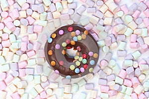 Donut in a round marshmallow frame on a white background. top view photo