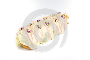 Donut shaped like a tube with sprinkels ontop. Delicios but unhealty sugar food photo