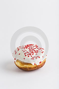 Donut with white chocolate icing and confiture on a white background, isolated