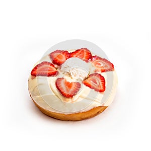 Donut with white cream and strawberry slices, isolated on white background. Viewing forty-five degrees