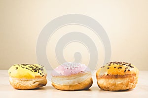 Donuts. Assorted donuts lying on a white table on background with copy space. Ð¡oncept sweet food