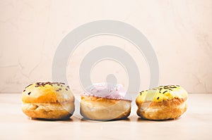 Donuts. Assorted donuts lying on a white table on white background. Ð¡oncept sweet food