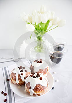Donuts and black coffee on a white background.