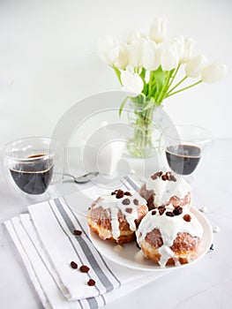 Donuts and black coffee on a white background.