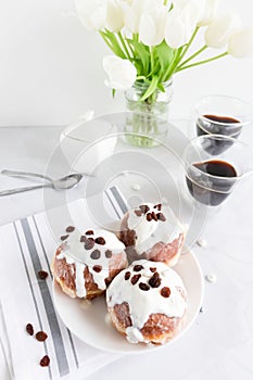 Donuts and black coffee on a white background.