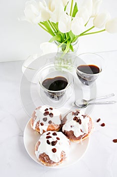 Donuts and black coffee on a white background.