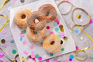 Donuts for carnival and party. Donuts with streamers and confetti