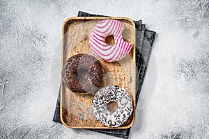 Donuts with chocolate, pink glazed and sprinkles Doughnut. White background. Top view