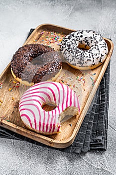 Donuts with chocolate, pink glazed and sprinkles Doughnut. White background. Top view