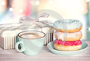 Donuts and coffee cup on colordul retro background.