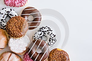 Donuts with colorful icing on a white background. Place for text