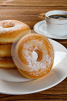 Donuts with cup of coffee vertical composition