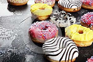 Donuts in different glazes with chocolate, sprinkles and stripes