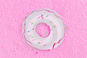 Donuts with icing on pastel pink background