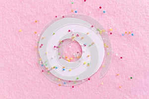 Donuts with icing on pastel pink background