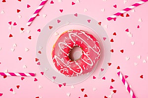 Donuts with icing on pastel pink background with copyspace. Sweet donuts