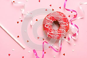 Donuts with icing on pastel pink background with copyspace. Sweet donuts