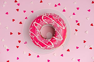 Donuts with icing on pastel pink background with copyspace. Sweet donuts.