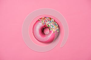 Donuts with icing on pastel pink background. Sweet donuts.