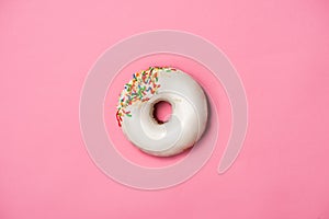 Donuts with icing on pastel pink background. Sweet donuts.
