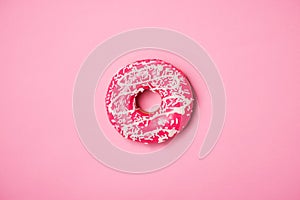 Donuts with icing on pastel pink background. Sweet donuts.