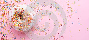 Donuts with icing on a pastel pink background. Sweet donuts. Flat lay. Banner