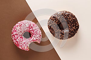 Donuts with icing on pink background.