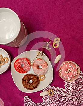 Donuts in a plate on a pink background