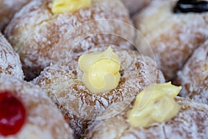 Donuts at street food market in Thailand, closeup. Tasty doughnuts with jam, chocolate and condensed milk