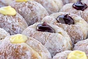 Donuts at street food market in Thailand, closeup. Tasty doughnuts with jam, chocolate and condensed milk