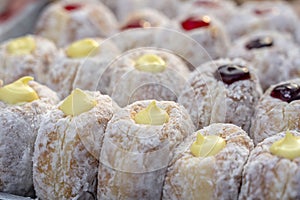 Donuts at street food market in Thailand, closeup. Tasty doughnuts with jam, chocolate and condensed milk