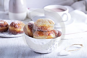 Donuts with sugar and cinnamon served with cocoa. Traditional dessert for Carnival.