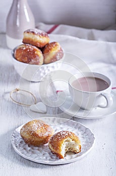 Donuts with sugar and cinnamon served with cocoa. Traditional dessert for Carnival.