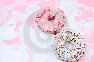 donuts on a white and pink background