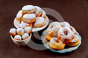 Donuts in white plate powdering with sugar