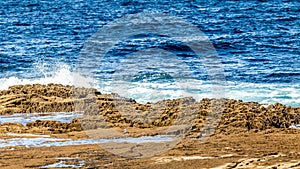 Doolin bay with limestone with waves in the sea