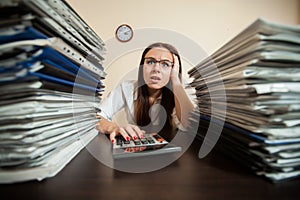 Doomed accountant against big stacks of documents