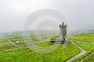 Doonagore Castle, round 16th-century tower house with a small walled enclosure located near the coastal village of Doolin in