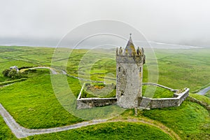 Doonagore Castle, round 16th-century tower house with a small walled enclosure located near the coastal village of Doolin in