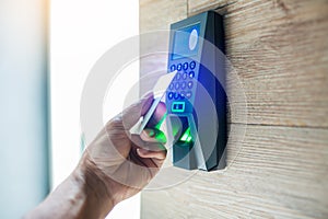 Door access control. Staff holding a key card to lock and unlock door at home or condominium