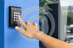 Door access control - young woman holding a key card to lock and unlock door., Keycard touch the security system to access the doo