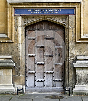 Door adorns a building amidst sturdy stone pillars and concrete walls